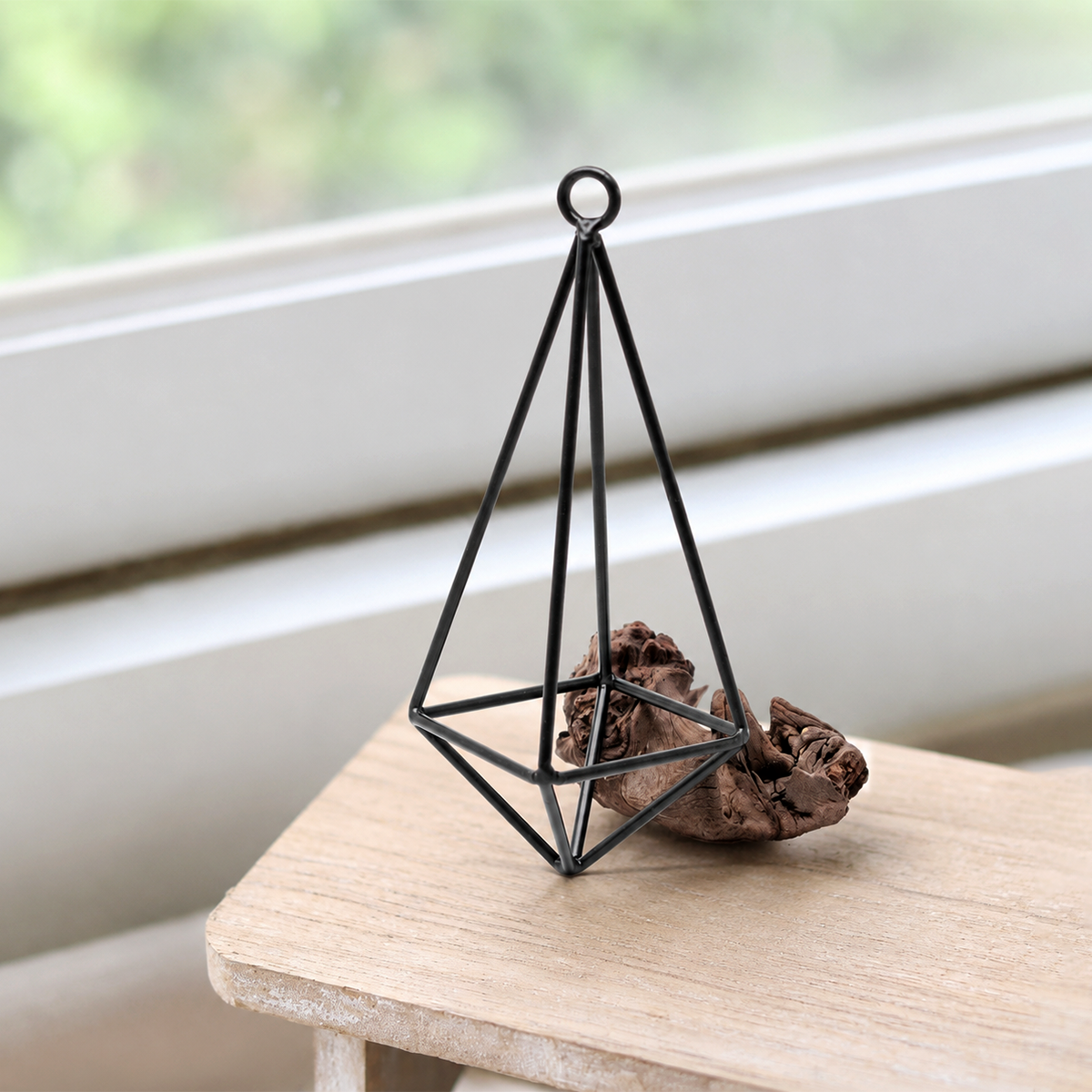 buy hanging metal pendant live air plant online, delicate trailing stems with slender green foliage, prefers bright indirect light away from scorching south-facing windows, requires regular rotating for balanced symmetric growth, sensitive to direct air from ac and heating vents so position away from drafts, thrives in humid kitchen environments near moisture sources, elegant living room hanging planter accent, thoughtful air plant gift idea for low-maintenance plant enthusiasts