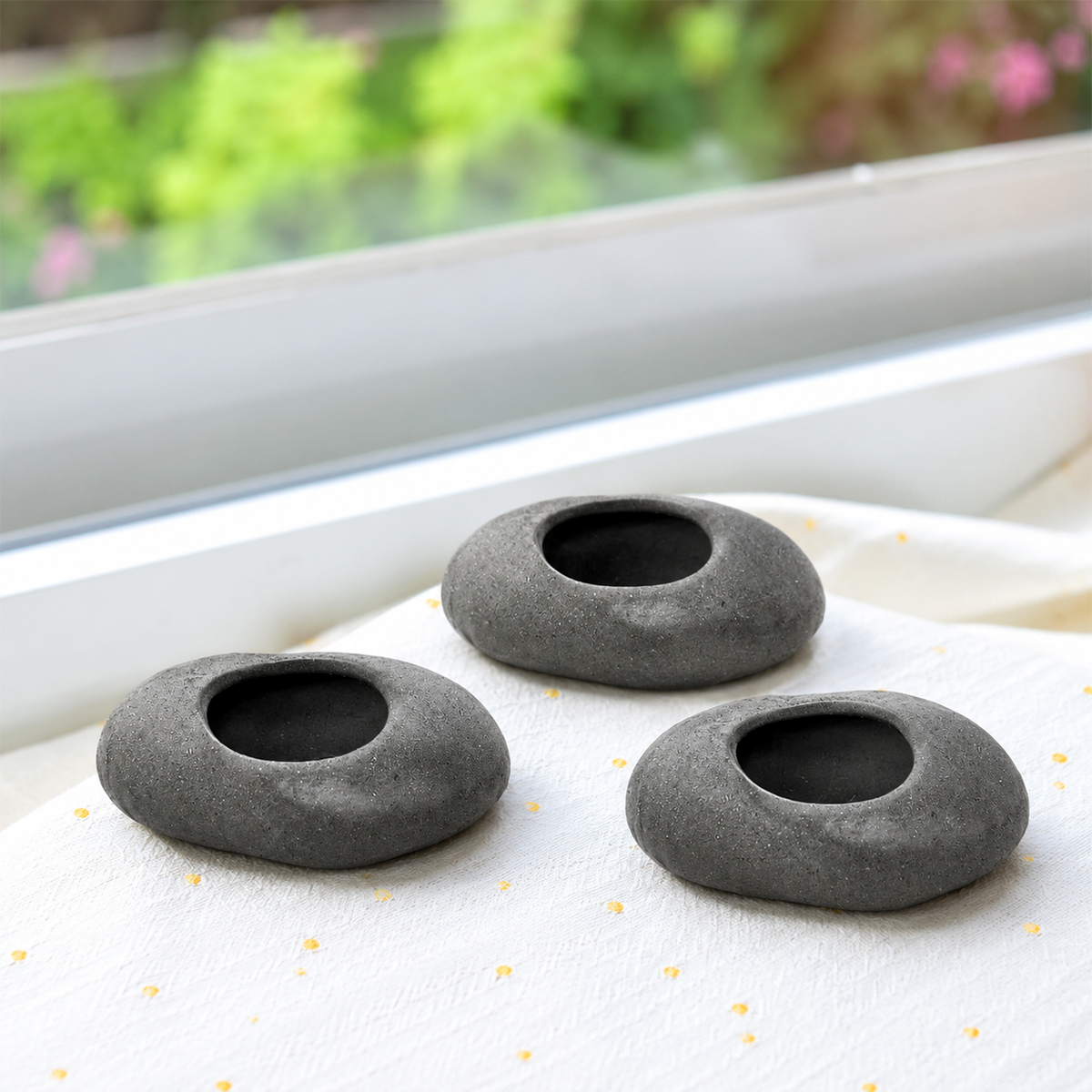 buy gray stone ceramic tillandsia air plant holder set 3 pack online, delicate silver-green threadlike leaves with graceful arching form, thrives near kitchen moisture and humidity, sensitive to direct ac or heater air currents so needs careful placement, requires rotating for even growth and prevents scorching in south windows, beautiful modern shelf accent, unique plant gift idea for air plant enthusiasts