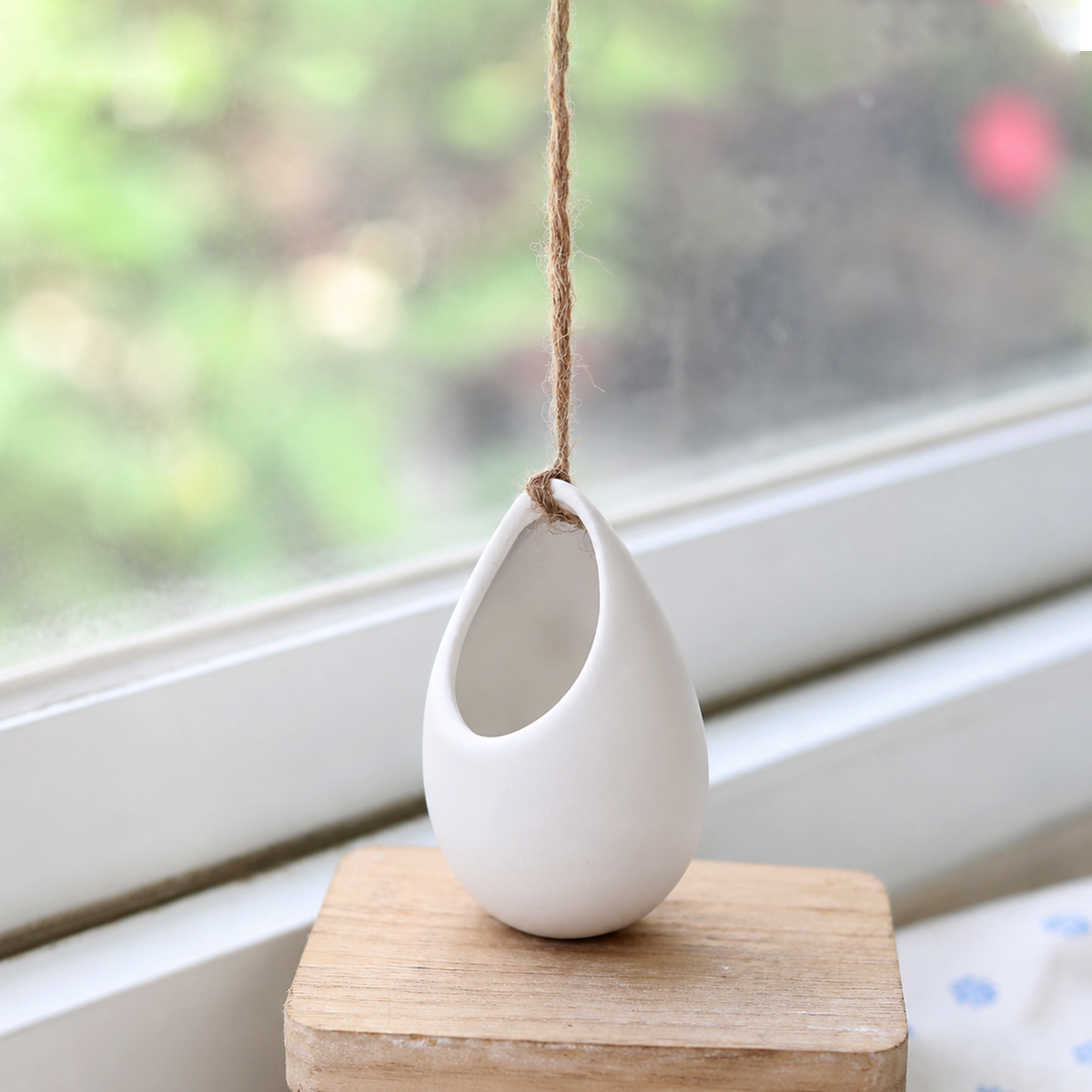 buy ivory ceramic hanging planter with flat bottom live plant 2 inch online, compact ivory matte ceramic vessel, smooth curved vase form, suited for silvery-green air plant or petite succulent, soil-free low maintenance display, dual-use hang or sit anywhere design, perfect minimalist desk or windowsill accent gift for plant lovers
