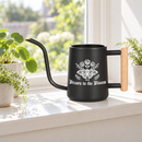 buy watering can drawn to the bloom black online, charming illustrated design with delicate floral artwork, durable plastic construction available in black orange gray or pink, ergonomic handle for easy pouring, ideal for indoor houseplants and garden beds, perfect gardening gift for plant enthusiasts