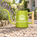 buy watering can drawn to the bloom black online, charming illustrated design with delicate floral artwork, durable plastic construction available in black orange gray or pink, ergonomic handle for easy pouring, ideal for indoor houseplants and garden beds, perfect gardening gift for plant enthusiasts