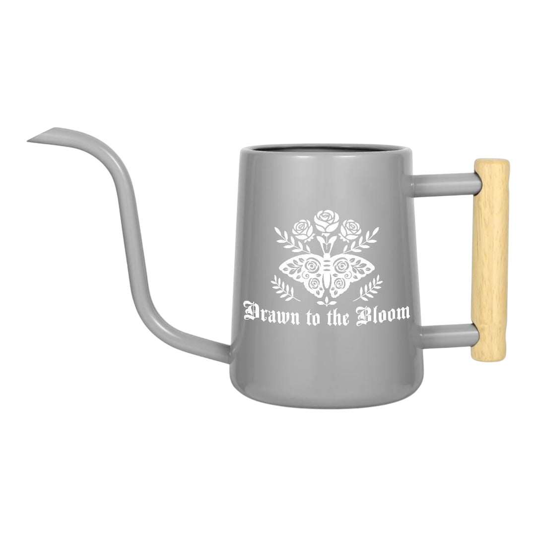 orange Watering Can - Drawn to the Bloom for sale, warm orange hue featuring artistic bloom artwork, compact size with comfortable grip handle, practical capacity for daily watering tasks, perfect for small herb gardens and patio containers, wonderful gift for garden hobby lovers