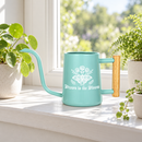 buy watering can drawn to the bloom black online, charming illustrated design with delicate floral artwork, durable plastic construction available in black orange gray or pink, ergonomic handle for easy pouring, ideal for indoor houseplants and garden beds, perfect gardening gift for plant enthusiasts