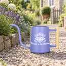 buy watering can drawn to the bloom black online, charming illustrated design with delicate floral artwork, durable plastic construction available in black orange gray or pink, ergonomic handle for easy pouring, ideal for indoor houseplants and garden beds, perfect gardening gift for plant enthusiasts